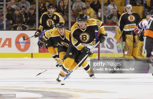 Phil Kessel of the Boston Bruins carries puck up ice against the New York Rangers during a preseason game at the TD Banknorth Garden on September 30,...