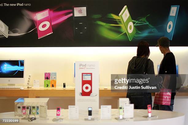 Apple store customers look at iPods on display October 19, 2006 in Emeryville, California. Apple Computer's fourth-quarter profit rose 27 percent,...