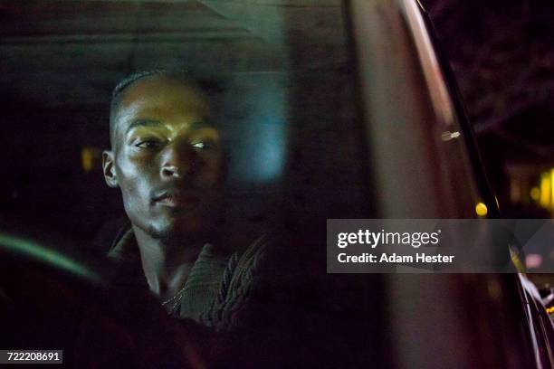 black man driving car - driving a car at night stock pictures, royalty-free photos & images