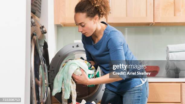 black woman doing laundry - trockner stock-fotos und bilder