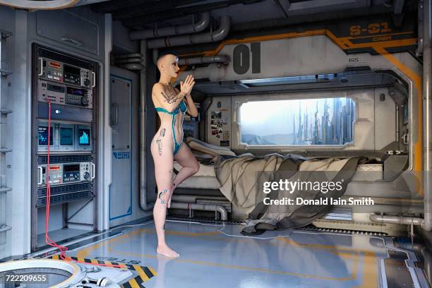 female cyborg practicing yoga in futuristic bedroom - soul city ストックフォトと画像