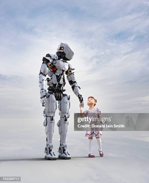 cyborg holding hands with girl - child with robot stockfoto's en -beelden