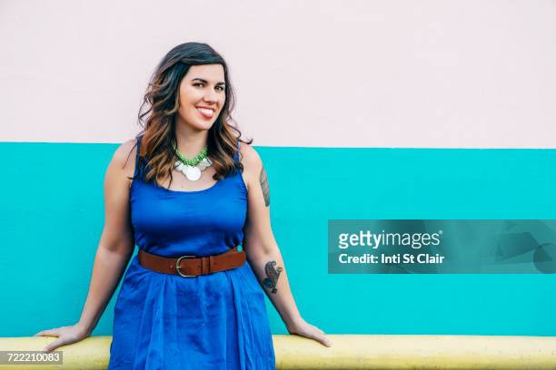 Portrait of smiling Mixed Race woman wearing blue dress