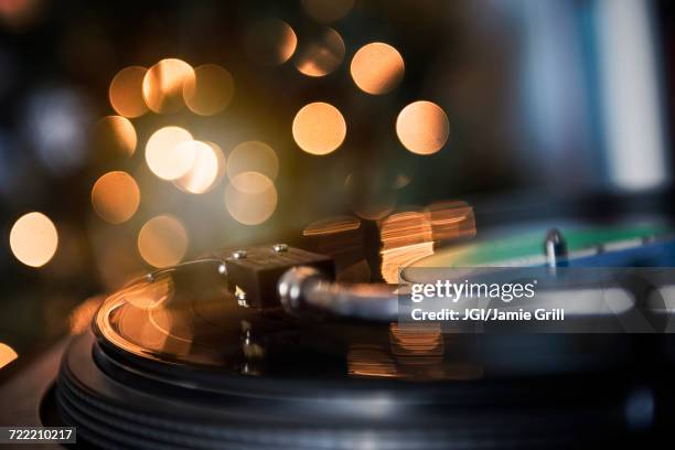 close up of tonearm on spinning record player - vintage record player no people ストックフォトと画像