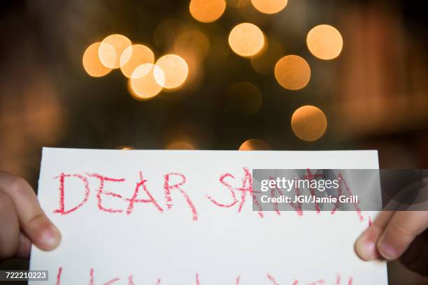 hands of caucasian girl holding dear santa letter - wunsch stock-fotos und bilder