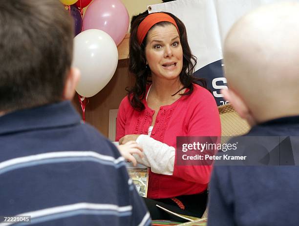 Actress Marcia Gay Harden reads a book to kids at The Ronald McDonald House of New York where they celebrated the auctioning of 25 Sleep Number beds...