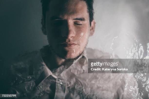 caucasian man wearing shirt laying underwater in bathtub - underwater room stock pictures, royalty-free photos & images