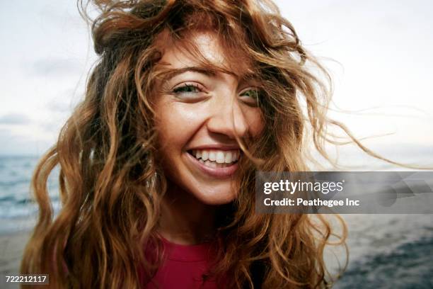 wind blowing hair of caucasian woman on beach - human hair close up stock pictures, royalty-free photos & images