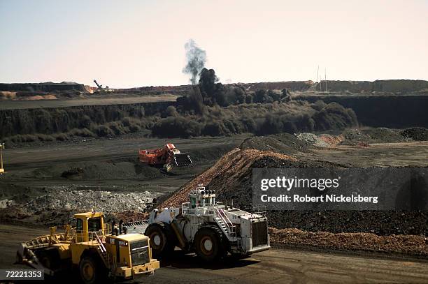 Heavy vehicles stop moving as a timed detonation brings down a wide coal face at the Buckskin Coal Mine, on June 13, 2006 in Gillette, Wyoming. The...