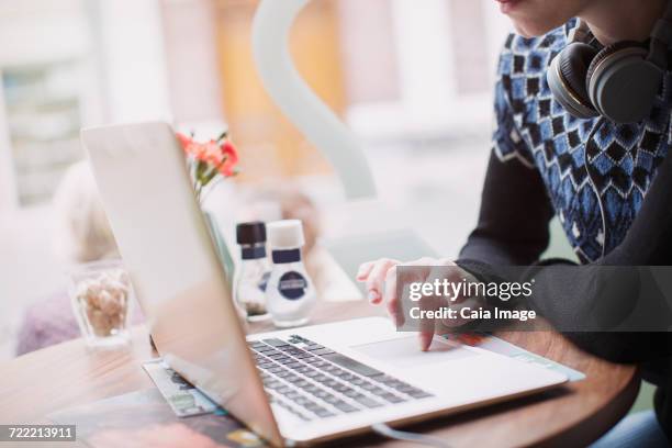 woman using laptop at cafe window - touch pad stock pictures, royalty-free photos & images