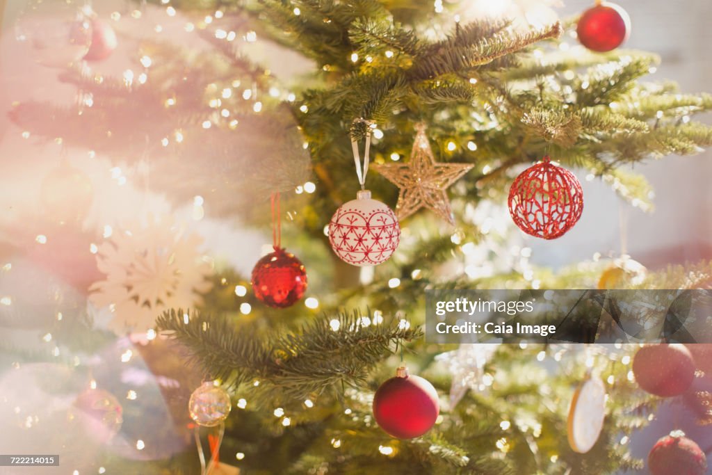 Red, white and gold ornaments and star on Christmas tree