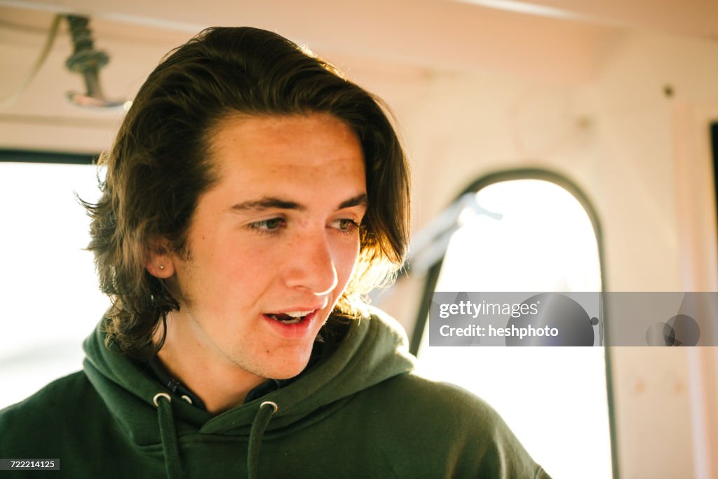 Teenage boy on fishing boat on coast of Maine, USA