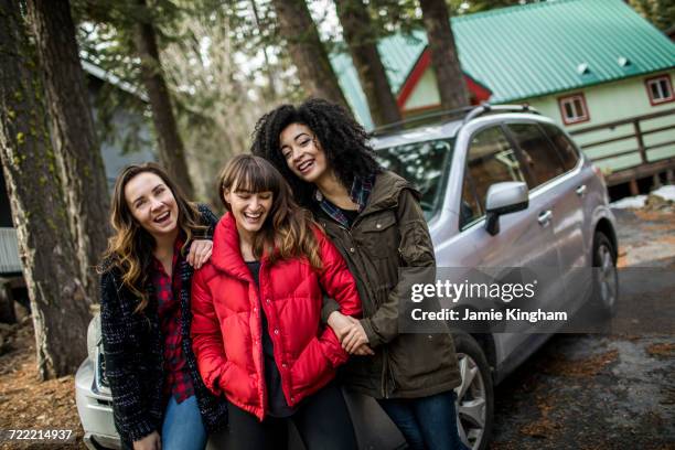 portrait of three friends standing beside car, laughing - nearby stock pictures, royalty-free photos & images