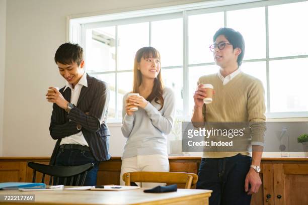 business people having coffee break in office - coffee break office ストックフォトと画像