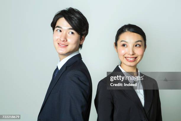 young businessman and woman looking each other - at a glance ストックフォトと画像