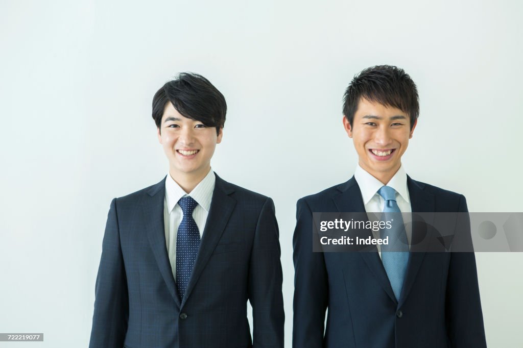 Two businessmen smiling