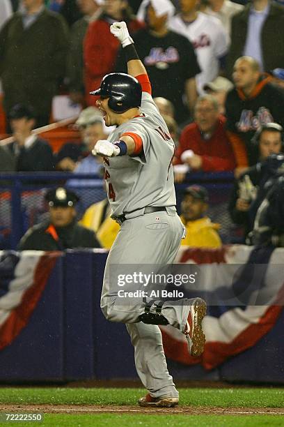 Yadier Molina of the St. Louis Cardinals pumps his fist as he rounds the bases after hitting a two-run homerun against the New York Mets to take the...