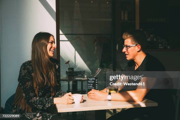 couple in a coffee shop having fun - coffee shop couple stock pictures, royalty-free photos & images