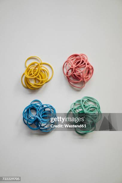 piles of multicolored rubber bands - persistence stock pictures, royalty-free photos & images