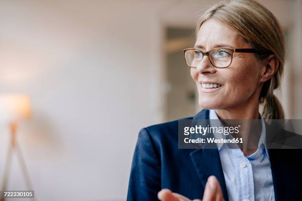 portrait of confident businesswoman wearing glasses - looking away stock pictures, royalty-free photos & images