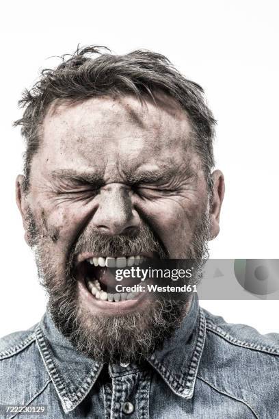 portrait of screaming man with dirty face - dirty face stock-fotos und bilder