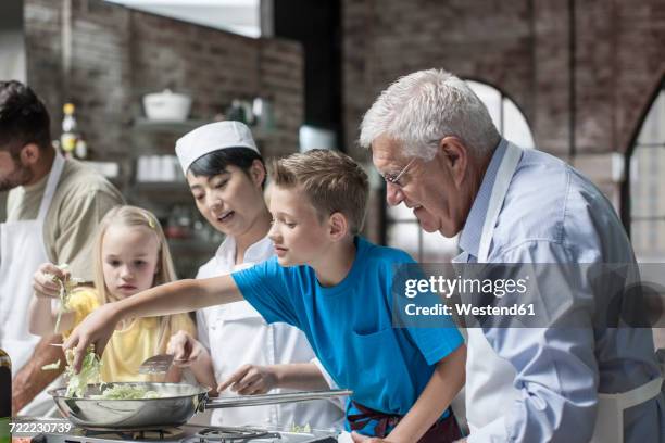 female chef and students cooking in cooking class - children cooking school stock pictures, royalty-free photos & images