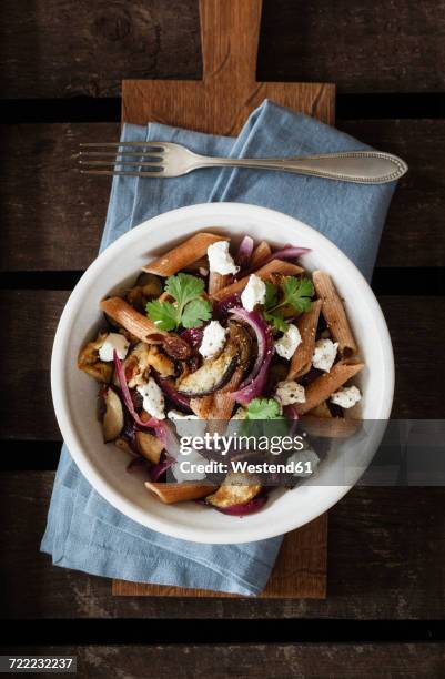 spelt rigatoni with aubergines, feta and raisins - sheeps milk cheese stock pictures, royalty-free photos & images