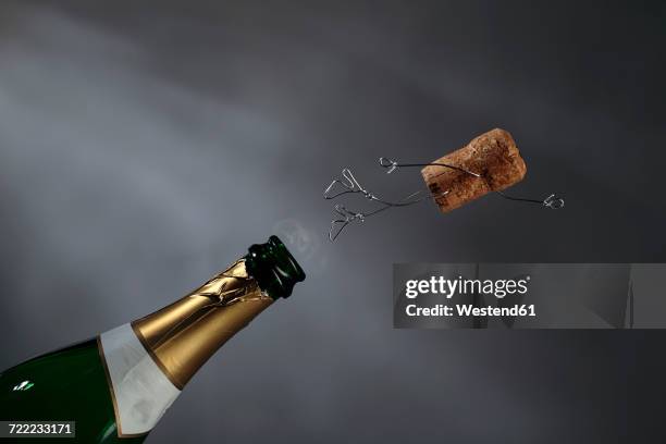 champagne cork manikin in the air - sektkorken stock-fotos und bilder