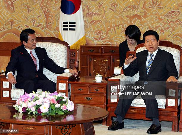 South Korean President Roh Moo-hyun talks with Japanese Foreign Minister Taro Aso at the presidential Blue House in Seoul 20 October 2006. Aso said...