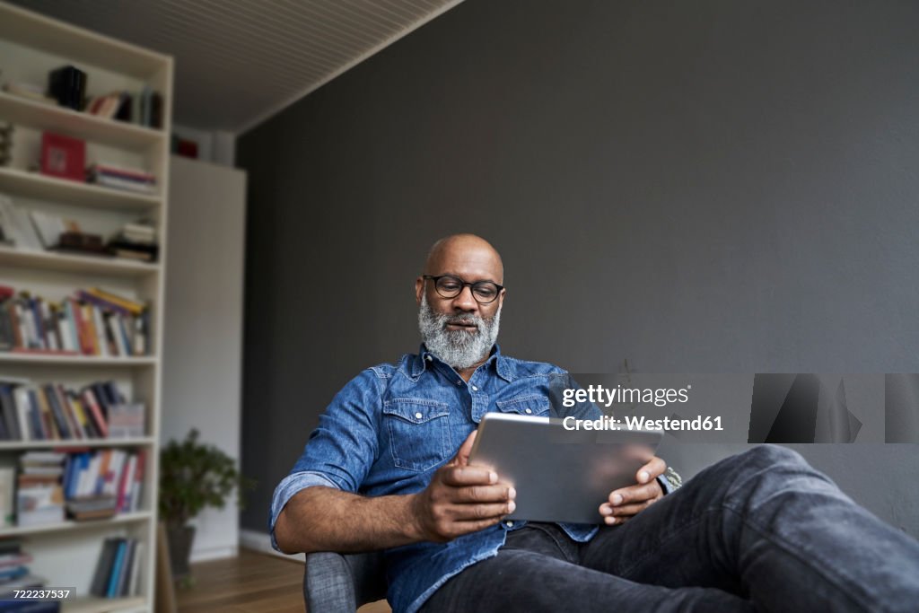 Mature man using digital tablet
