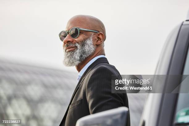 portrait of a mature businessman - best sunglasses for bald men stock pictures, royalty-free photos & images