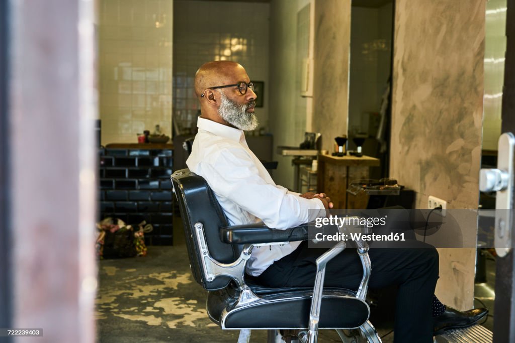 Mature businessman reading smartphone messages