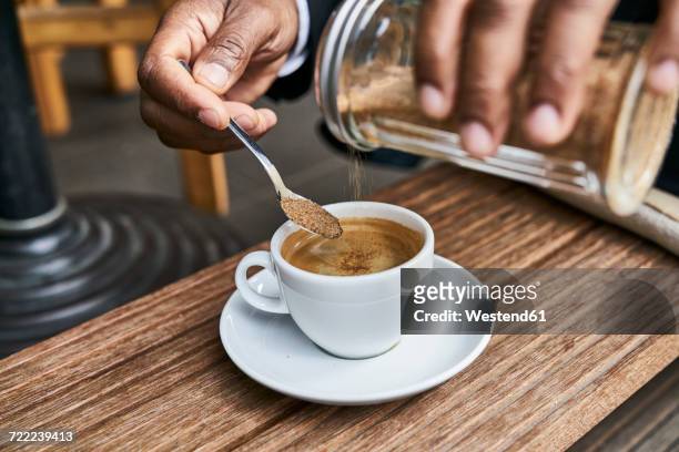 man sitting in cafe, drinking coffee - sugar ストックフォトと画像