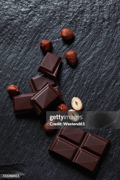 bittersweet chocolate and hazelnuts on slate - schist stock-fotos und bilder