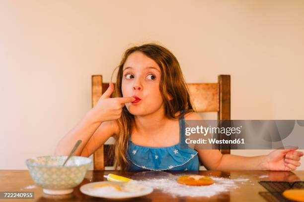 portrait of girl decorating biscuits at home - indulgence stock pictures, royalty-free photos & images