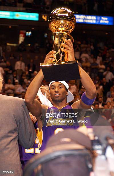 Kobe Bryant of the Los Angeles Lakers celebrates with the NBA Championship Trophy after winning the 2002 NBA Championship against the New Jersey Nets...
