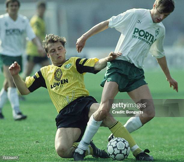 Dirk Zander of Dresden and Manfred Bockenfeld of Bremen fight for the ball during the Bundesliga match between Werder Bremen and Dynamo Dresden at...