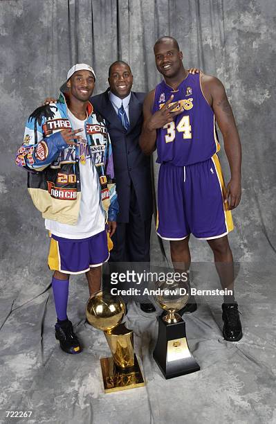 Kobe Bryant, Magic Johnson and Shaquille O'Neal of the Los Angeles Lakers pose for a portrait after winning the 2002 NBA Championship against the New...