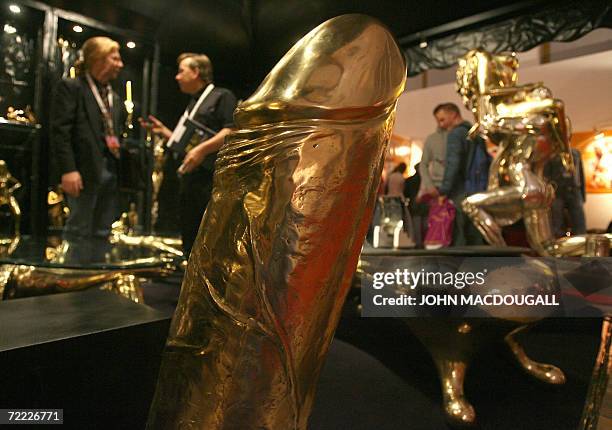 Sculpture of a golden giant erect phallus is featured at a stand specialising in erotic sculptures during the 10th Venus International Erotic Trade...