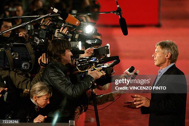 Actor Harrison Ford answers journalists question as he arrives at Rome's Auditorium 20 October 2006 during the first edition of the Rome Film...