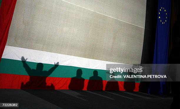 Shadows cast on Bulgarian and the EU flag of the ultra nationalist presidential candidate Volen Siderov and his party-goers during the final meeting...