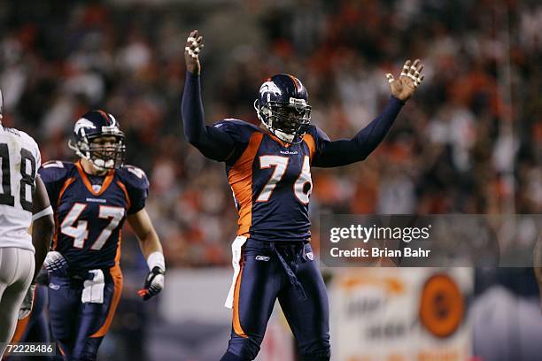 Defensive end Kenard Lang of the Denver Broncos raises his arms against the Oakland Raiders on October 15, 2006 at Invesco Field at Mile High in...