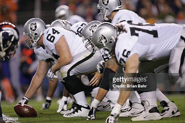 Center Jake Grove of the Oakland Raiders prepares to hike the ball against the Denver Broncos on October 15, 2006 at Invesco Field at Mile High in...