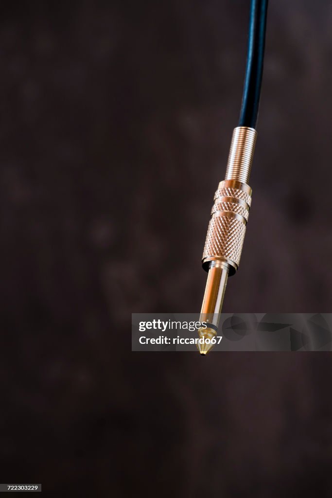 Close-Up Of Audio Cables Hanging Against Wall