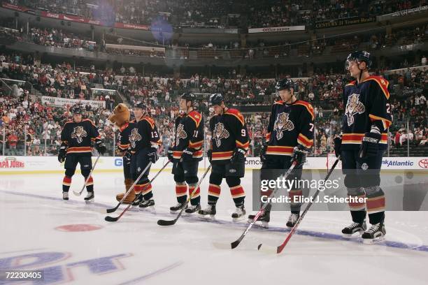 Juraj Kolnik, Gregory Campbell, Stephen Weiss, Steve Montador and Branislav Mezei of the Florida Panthers stand for the National Anthem before the...