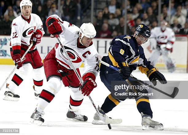 Rod Brind'Amour of the Carolina Hurricanes gains control of a faceoff against Derek Roy of the Buffalo Sabres on October 20, 2006 at HSBC Arena in...