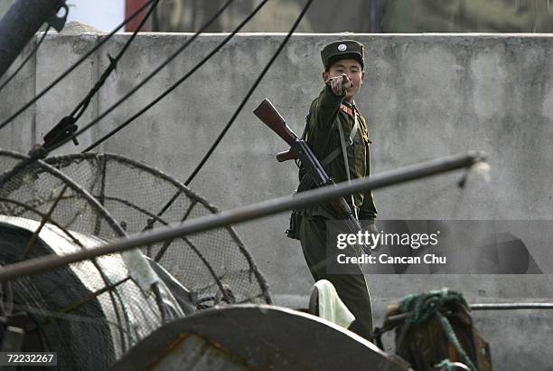 North Korean soldier reacts to be photographed on the banks of the Yalu River in the North Korean town of Sinuiju, opposite the Chinese border city...