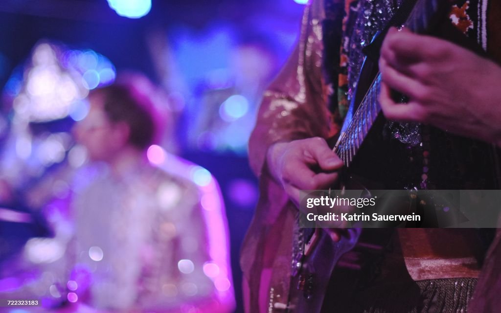 Midsection Of Man Playing Guitar