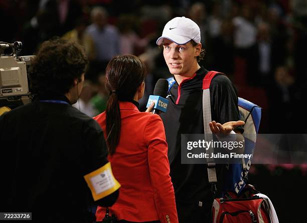 Tomas Berdych of Czech Republic is interviewed and receives a hostile reception from the crowd after his loss to Fernando Gonzalez of Chile in the...