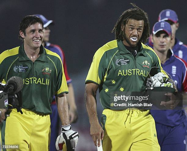 Mike Hussey and Andrew Symonds of Australia leave the field after their team's win after the ICC Champions Trophy match between Australia and England...